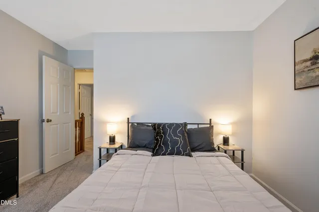 a bedroom with a bed and lamp