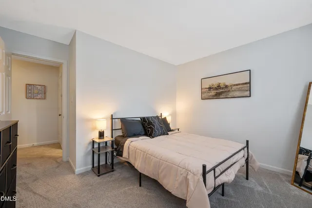 a bedroom with a bed and a night stand