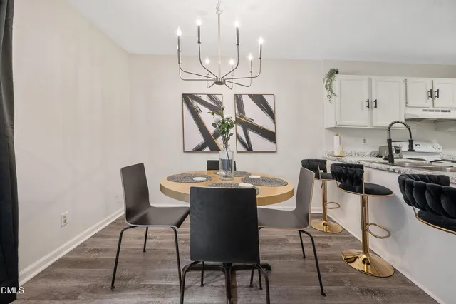 a view of a dining room with furniture and chandelier