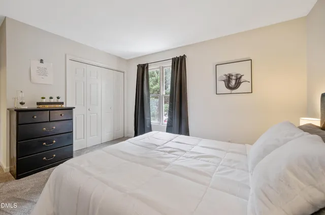 a bedroom with a bed and a dresser