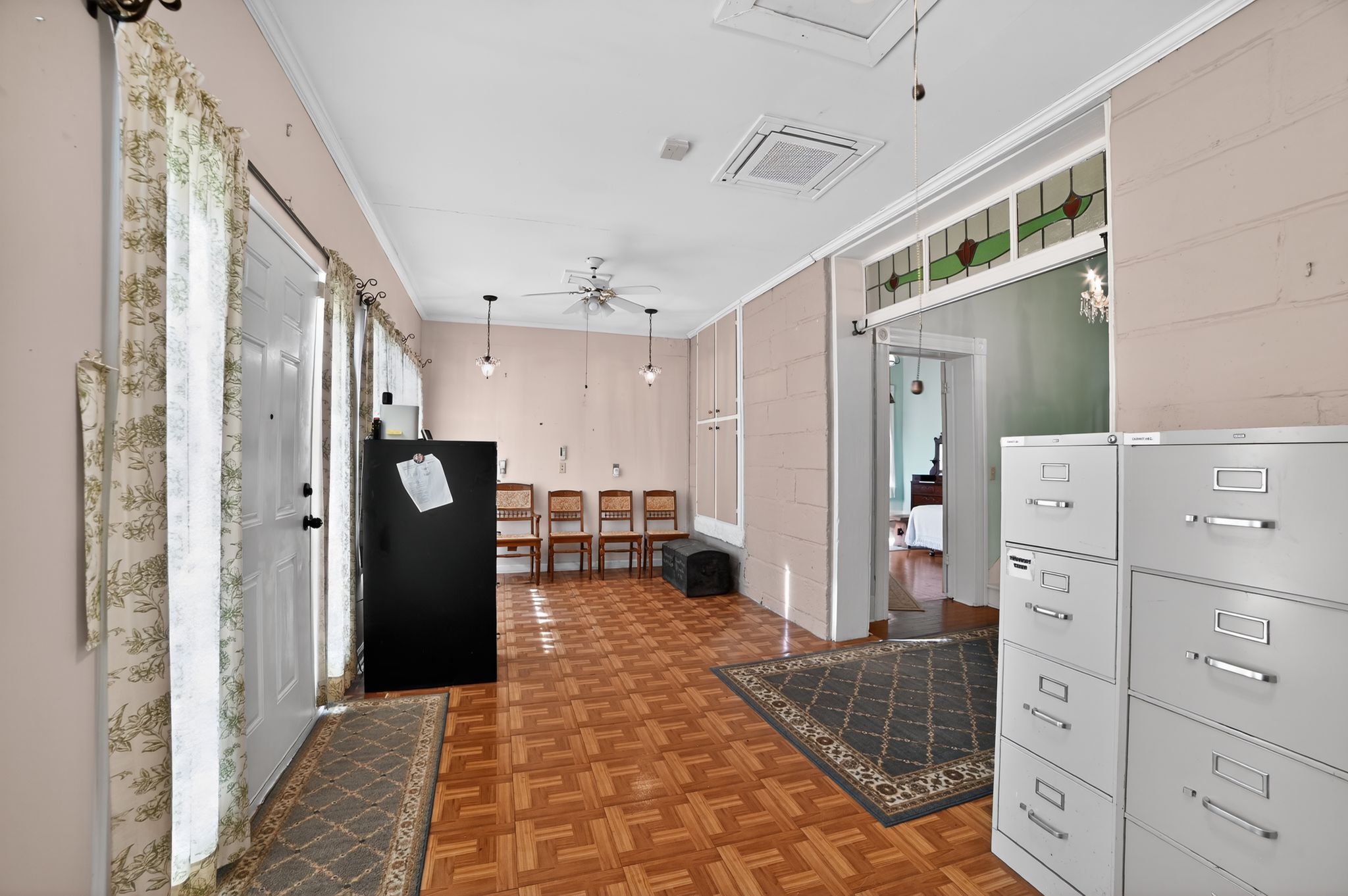 400 South Main Street Belton, TX 76513 - Photo 3 of 18 Entryway with parquet flooring, crown molding, and ceiling fan
