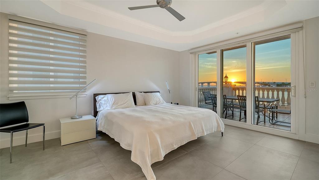 166 Golden Gate Point, Unit 22 Sarasota, FL 34236 - Photo 24 of 49 a bedroom with a large bed and a balcony view