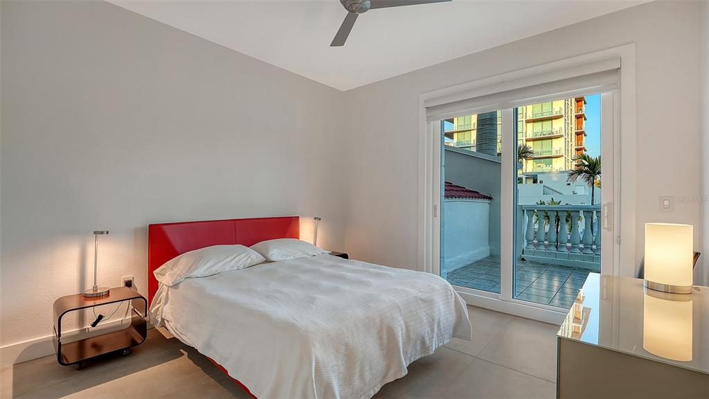 166 Golden Gate Point, Unit 22 Sarasota, FL 34236 - Photo 29 of 49 a bedroom with a bed and a large window