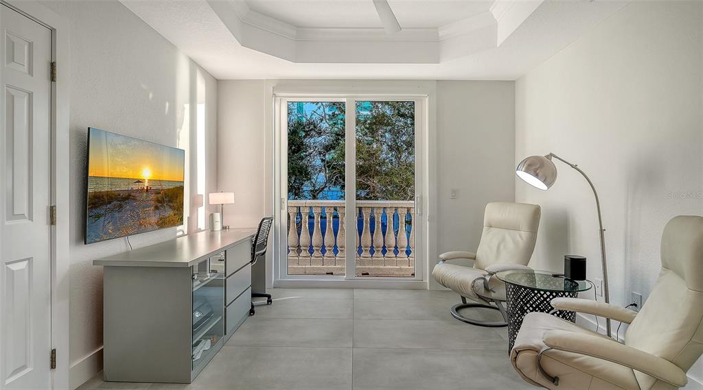 166 Golden Gate Point, Unit 22 Sarasota, FL 34236 - Photo 29 of 51 a living room with furniture and a flat screen tv