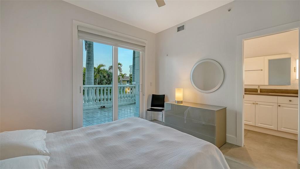 166 Golden Gate Point, Unit 22 Sarasota, FL 34236 - Photo 30 of 49 a bedroom with a bed closet and a mirror