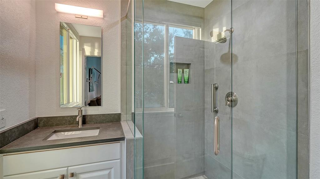 166 Golden Gate Point, Unit 22 Sarasota, FL 34236 - Photo 33 of 49 a bathroom with a sink and a mirror