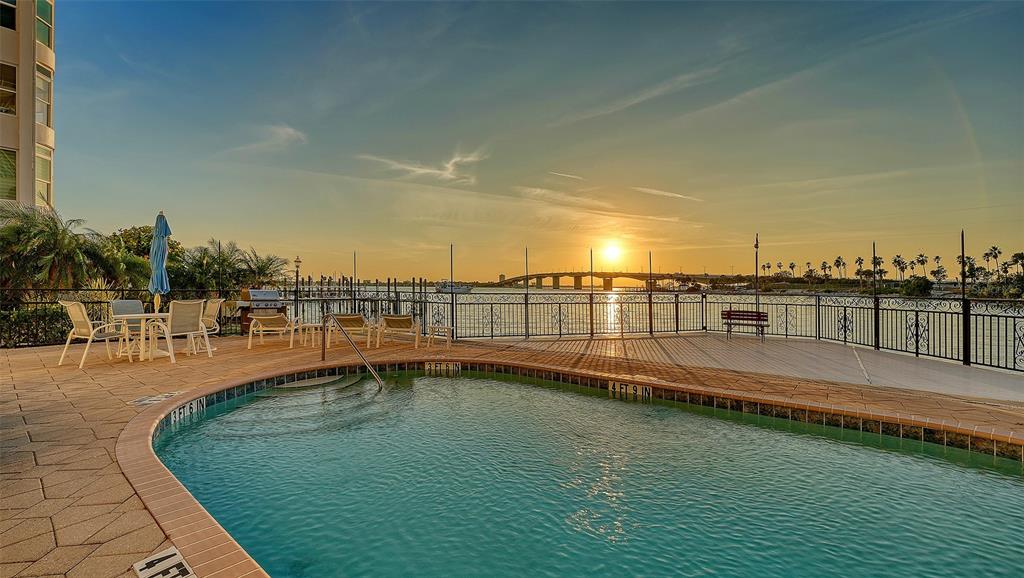 166 Golden Gate Point, Unit 22 Sarasota, FL 34236 - Photo 7 of 49 a view of a swimming pool with an ocean view