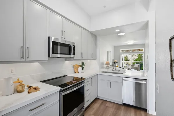 a kitchen with a sink cabinets and wooden floor