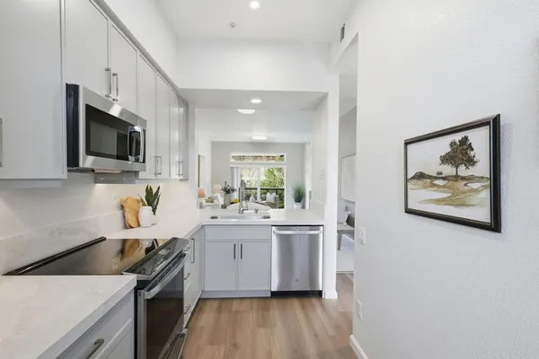 a kitchen with a sink and a refrigerator