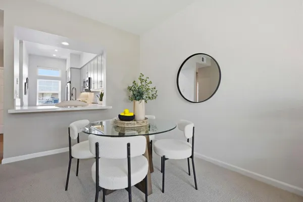 a kitchen with a table and chairs in it