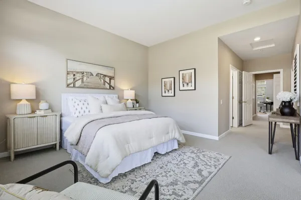 a bedroom with a bed and a large window