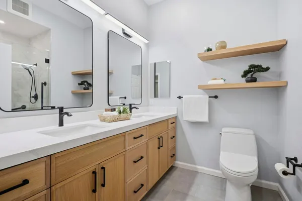 a bathroom with a sink toilet and shower