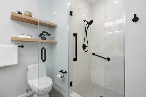 a bathroom with a bath tub with a shower