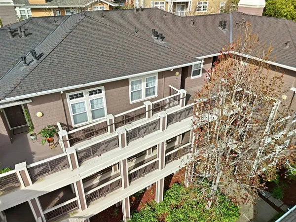 an aerial view of a house with wooden floor and city view