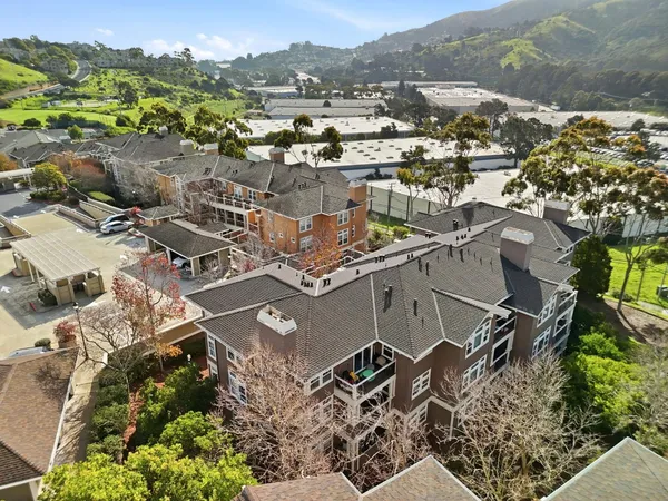 an aerial view of multiple houses with yard