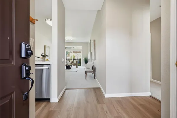 a view of a living room with furniture and wooden floor