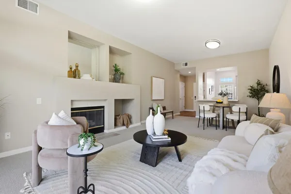 a living room with furniture and a fireplace
