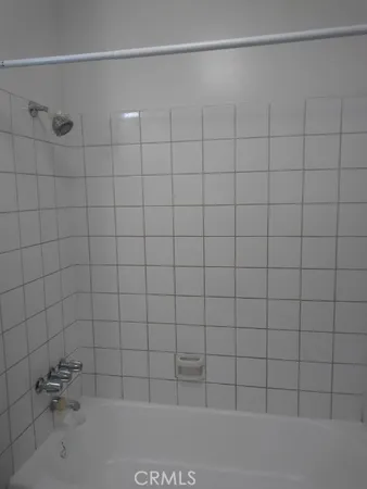 a bathroom with a window and a shower