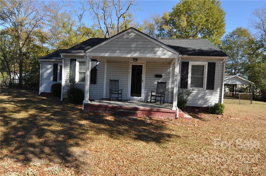 a view of a house with backyard porch and sitting area