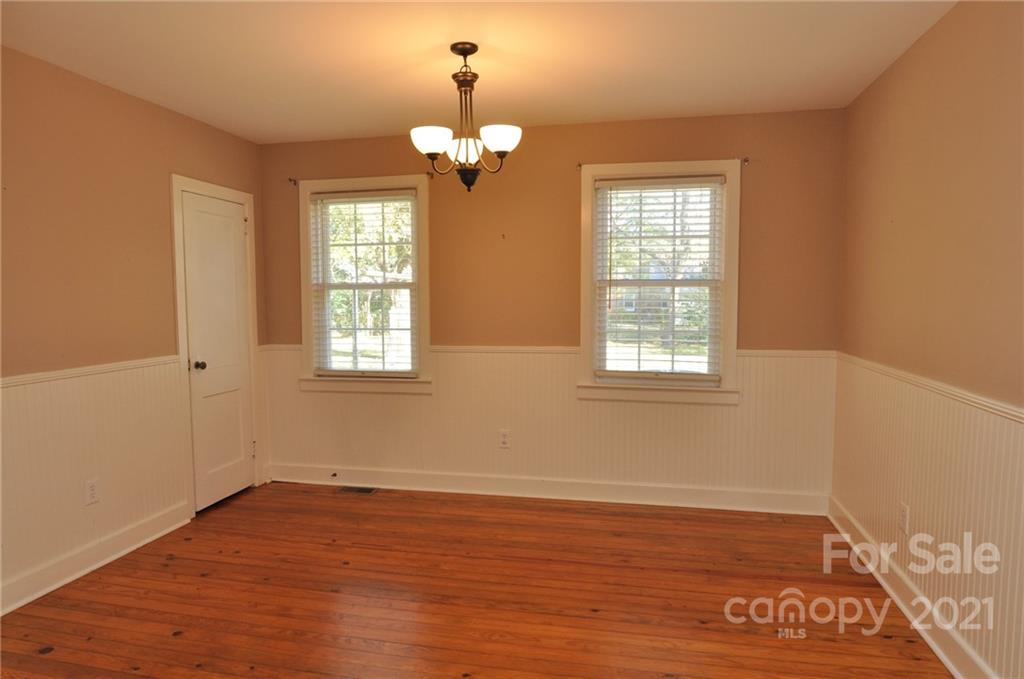 623 Sanders Street Chester, SC 29706 - Photo 11 of 20 a view of an empty room with wooden floor and a window
