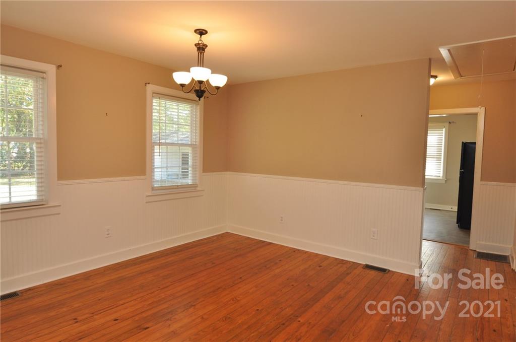 623 Sanders Street Chester, SC 29706 - Photo 12 of 20 a view of empty room with wooden floor and fan