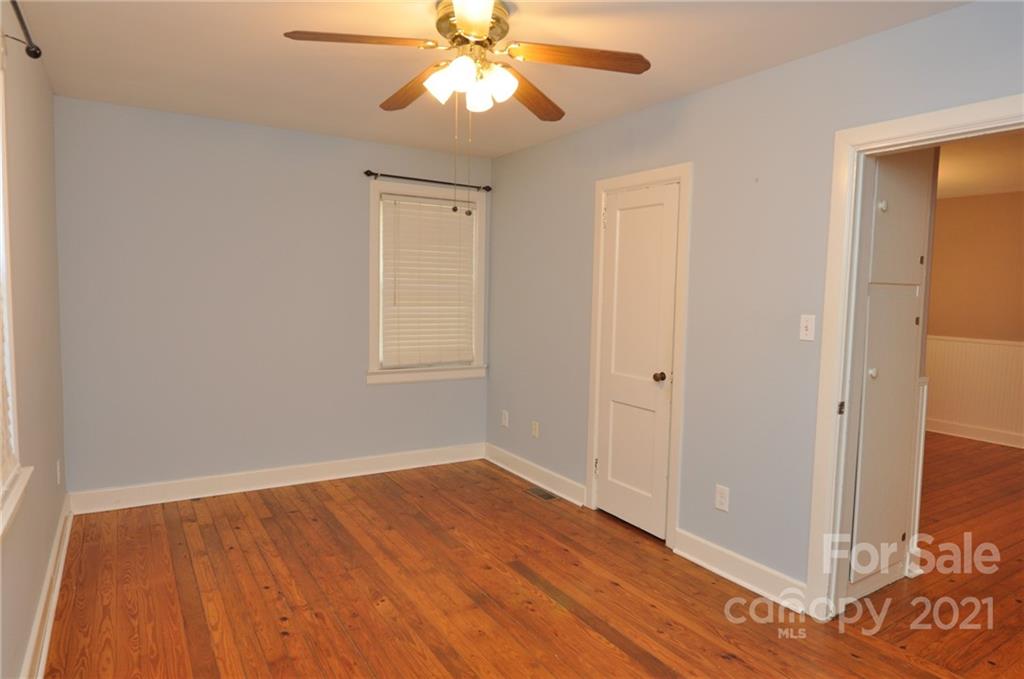623 Sanders Street Chester, SC 29706 - Photo 14 of 20 an empty room with wooden floor closet and windows