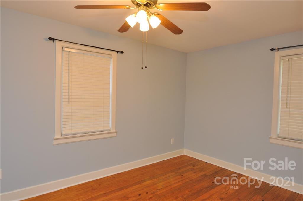 623 Sanders Street Chester, SC 29706 - Photo 15 of 20 a view of an empty room with wooden floor and a window