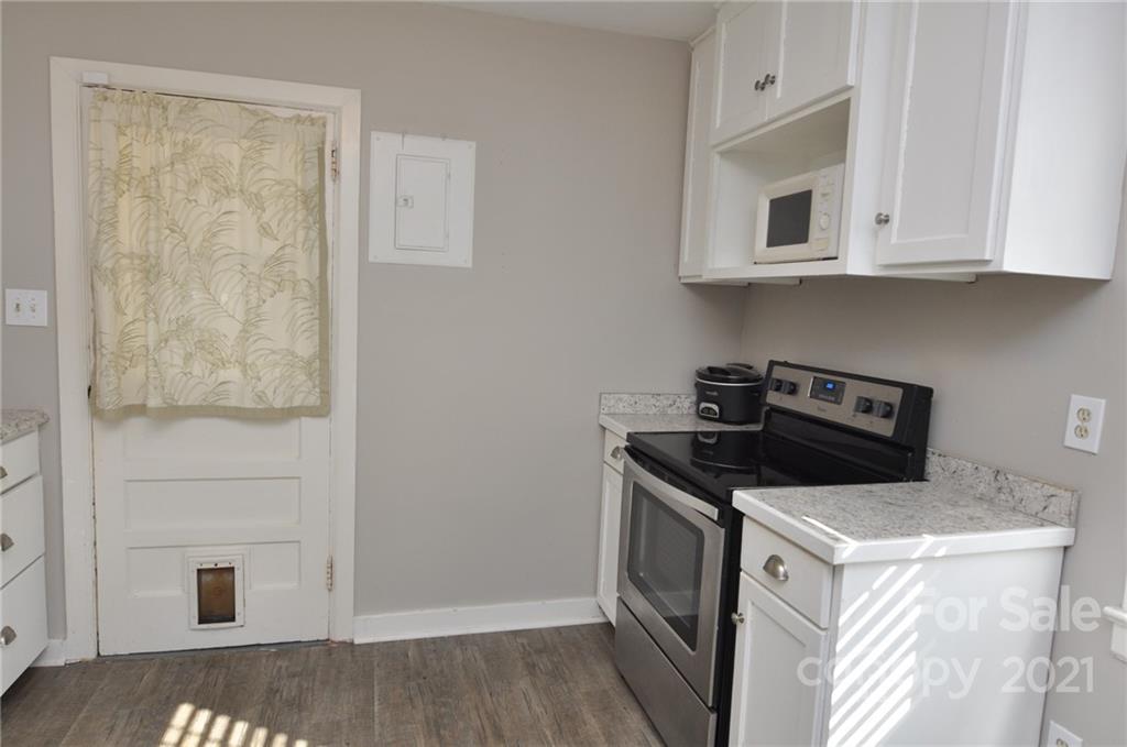 623 Sanders Street Chester, SC 29706 - Photo 6 of 20 a kitchen with white cabinets and white appliances
