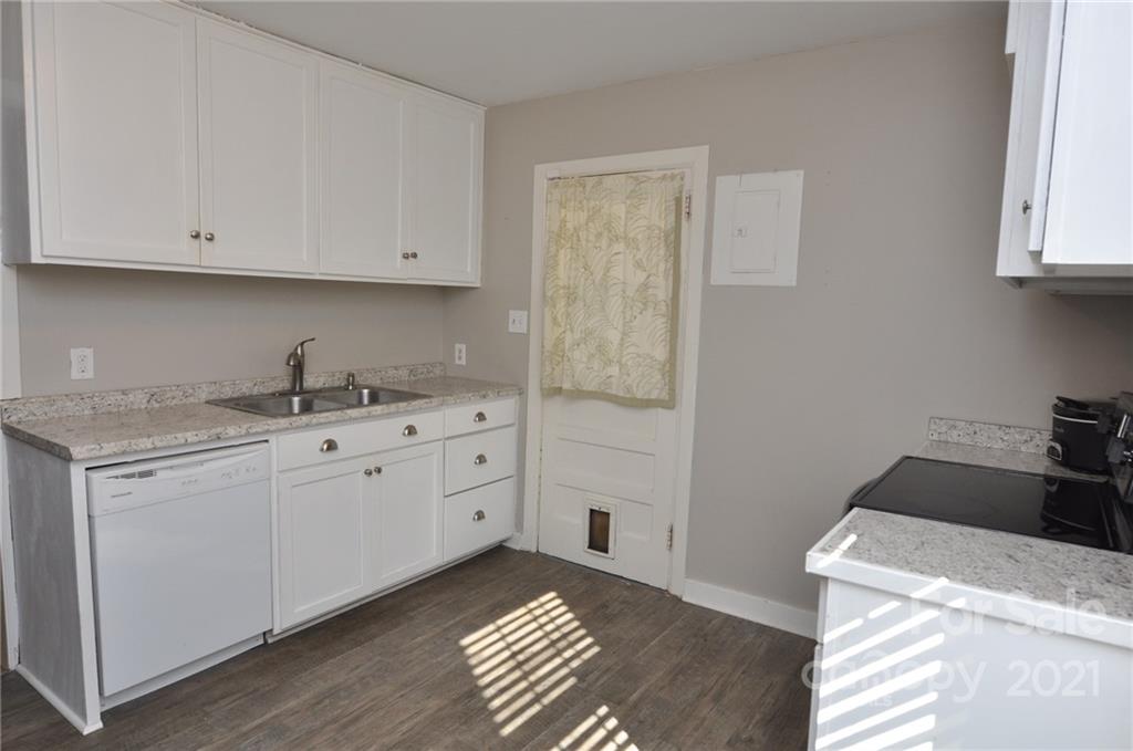 623 Sanders Street Chester, SC 29706 - Photo 7 of 20 a kitchen with white cabinets and sink