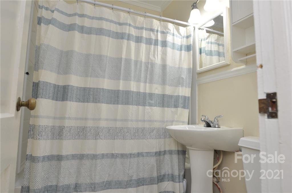 623 Sanders Street Chester, SC 29706 - Photo 10 of 20 a bathroom with a sink a mirror and shower curtain