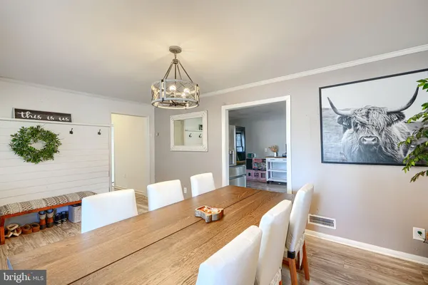 a view of a dining room with furniture and a chandelier