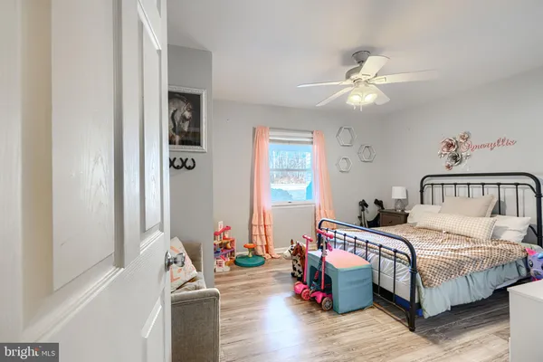 a bedroom with bed and a chandelier