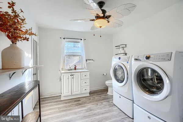 a utility room with sink dryer and washer
