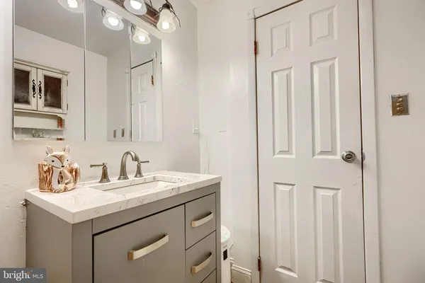 a bathroom with a sink a vanity and a mirror
