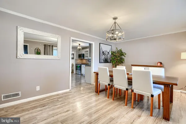 a view of a dining room with furniture and chandelier
