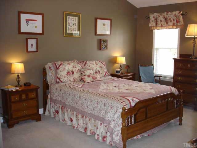 3521 Boren Court Raleigh, NC 27616 - Photo 6 of 10 a bedroom with a bed and a window