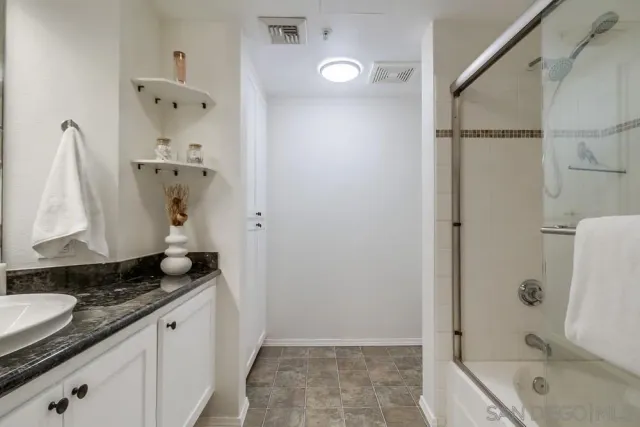 a bathroom with a bathtub and a shower