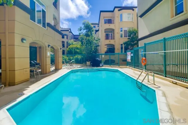 a view of house with swimming pool outdoor seating
