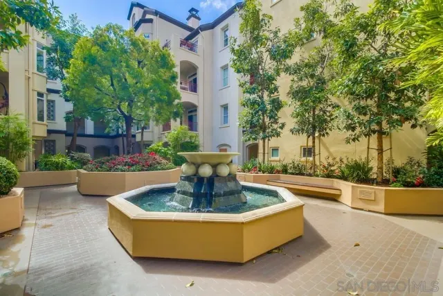 a living room with furniture a lamp and a chandelier