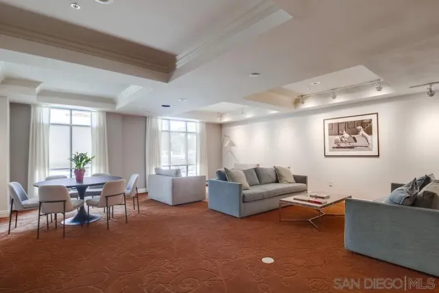 a living room with furniture a fireplace and a large window