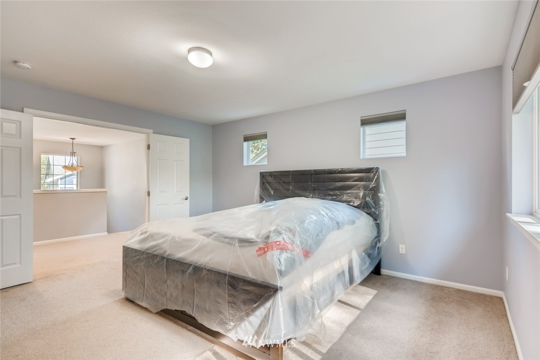 1208 231st Street Southwest Bothell, WA 98021 - Photo 22 of 24 a bedroom with a bed and a window