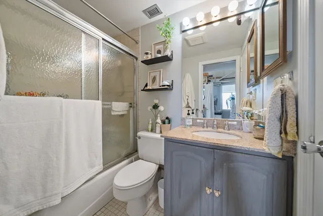 a bedroom with bed and wooden floor