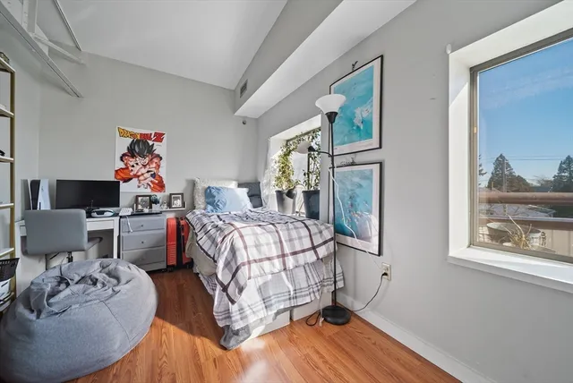 a bedroom with a bed and a potted plant