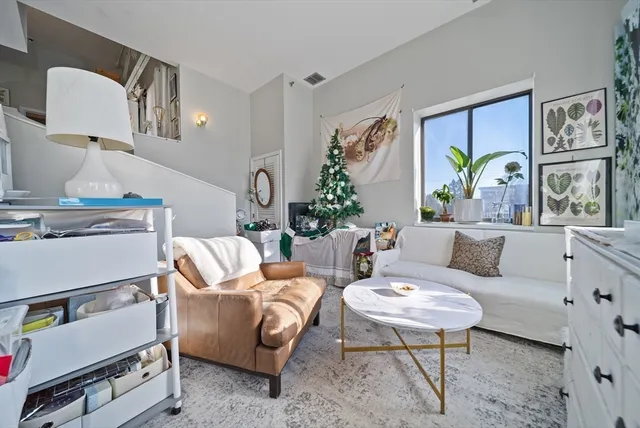 a living room with furniture and painting on the wall