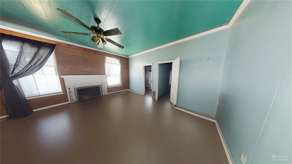 688 Main Street Whitesburg, GA 30185 - Photo 16 of 34 a view of a livingroom with wooden floor a ceiling fan and windows