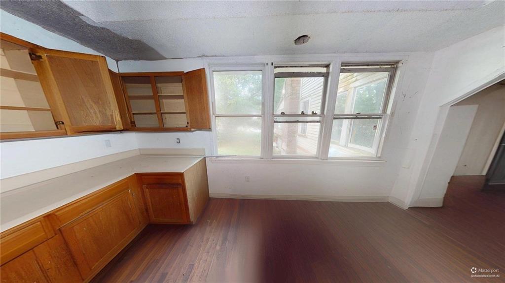 688 Main Street Whitesburg, GA 30185 - Photo 7 of 34 an empty room with wooden floor and windows