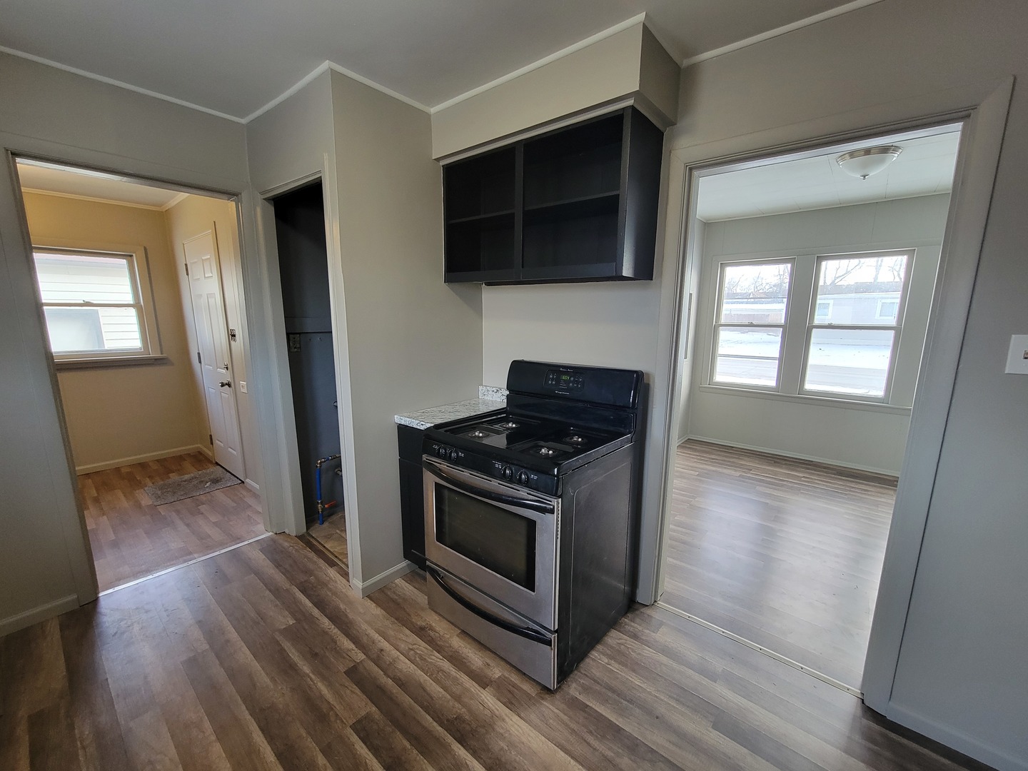 802 Deleon Street Ottawa, IL 61350 - Photo 15 of 22 a kitchen with stainless steel appliances a stove a microwave oven cabinets and wooden floor