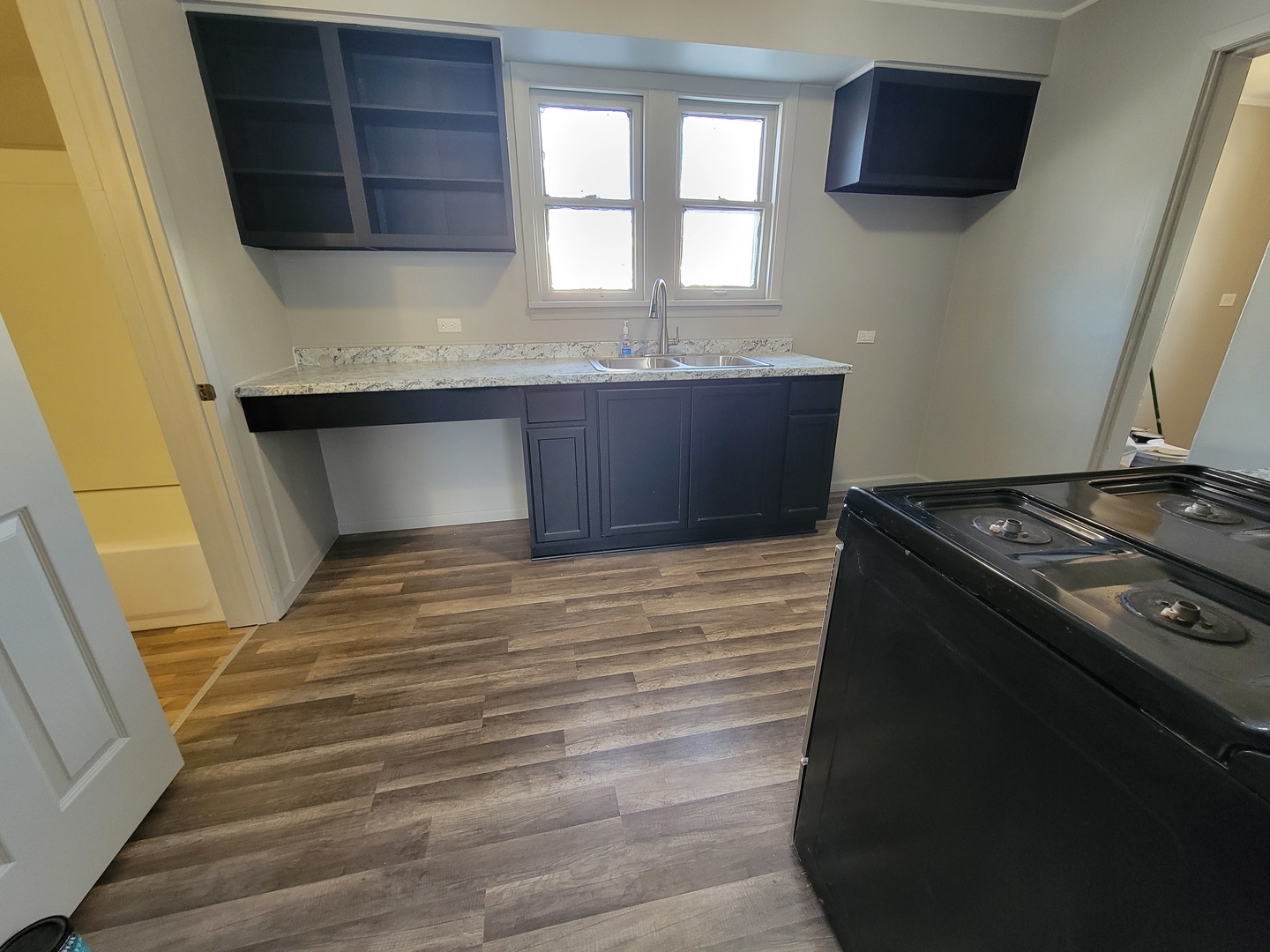 802 Deleon Street Ottawa, IL 61350 - Photo 17 of 22 a kitchen with a stove and a granite wooden floor