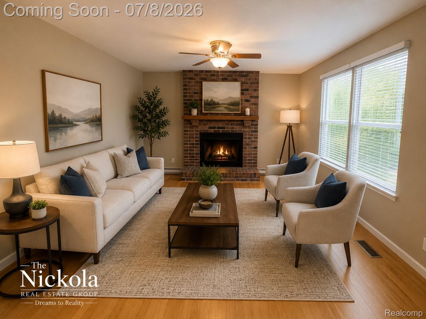 414 Whitney Drive Rochester, MI 48307 - Photo 12 of 30 Living room featuring brick fireplace with a wood mantle, wood-finish flooring, two large windows with blinds, and a ceiling fan with integrated lighting