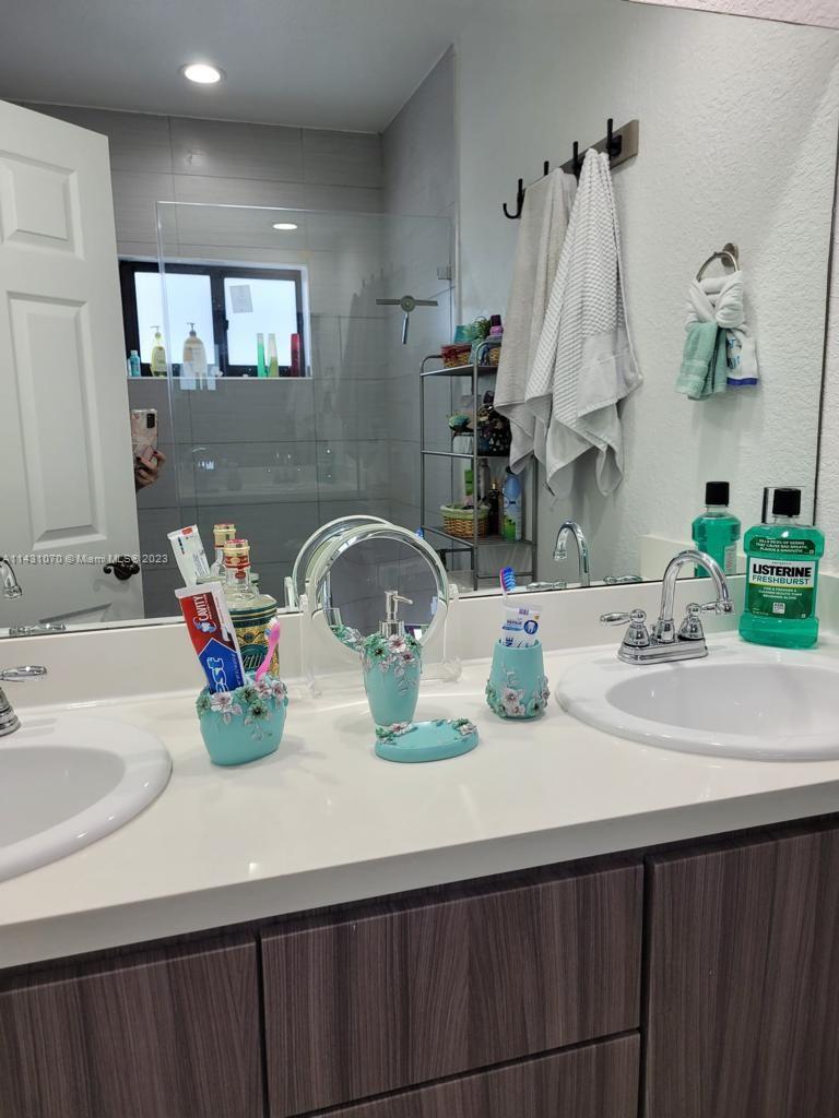 16383 Southwest 44th Terrace Miami, FL 33185 - Photo 13 of 24 a bathroom with a sink and a mirror